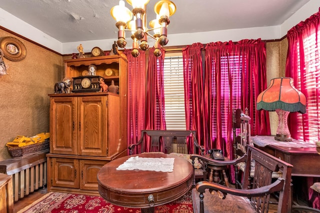 sitting room featuring a textured ceiling and a chandelier