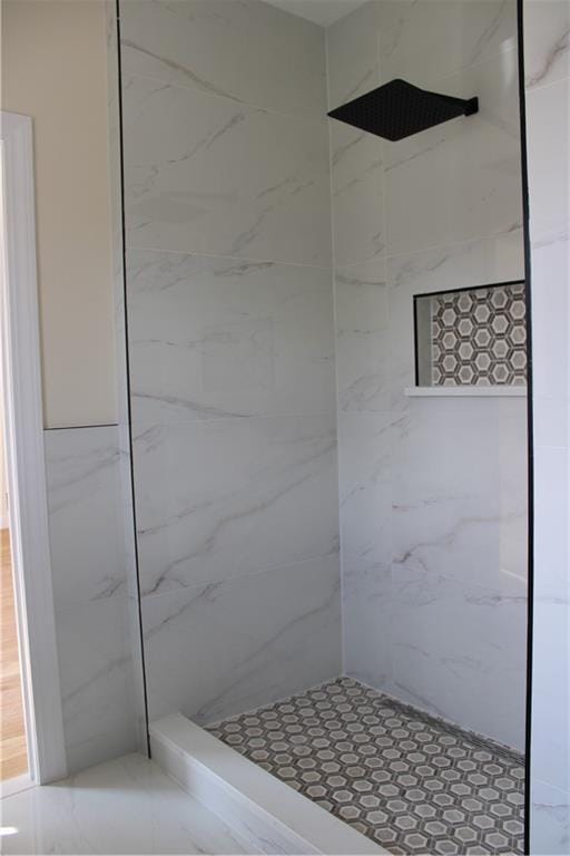 bathroom with a tile shower