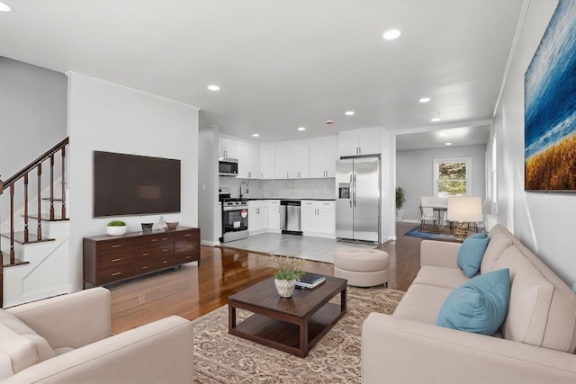 living room with light wood-type flooring and sink