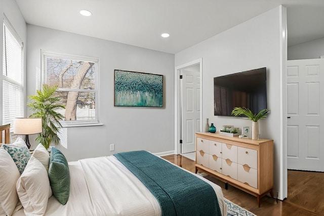 bedroom with dark hardwood / wood-style flooring