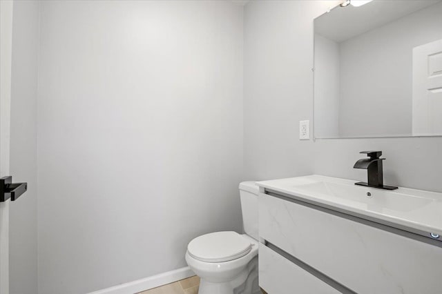 bathroom featuring tile patterned flooring, vanity, and toilet