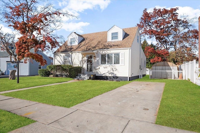 cape cod-style house featuring a front lawn