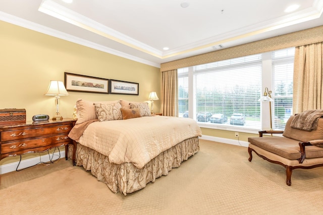 bedroom featuring a tray ceiling, crown molding, and carpet floors