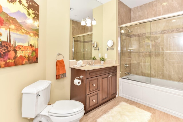 full bathroom with shower / bath combination with glass door, vanity, and toilet