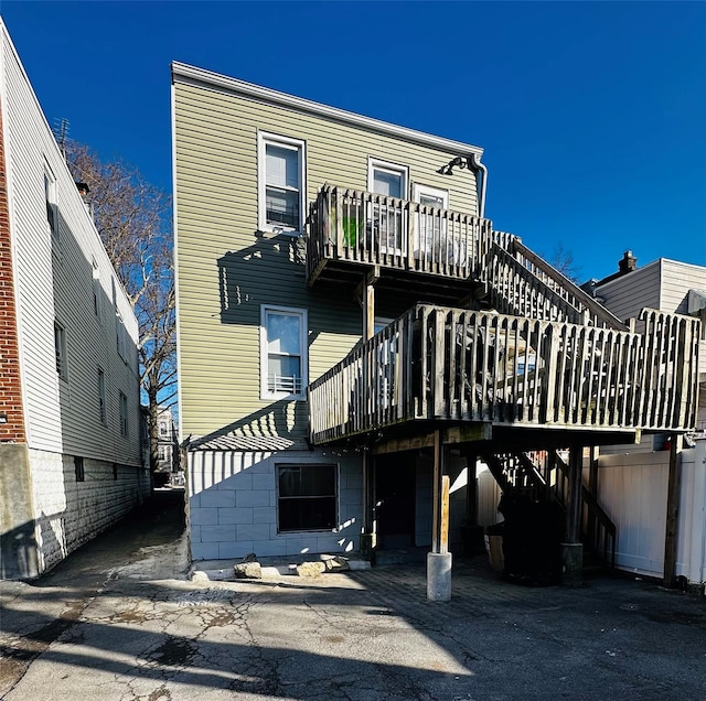 rear view of house featuring a deck