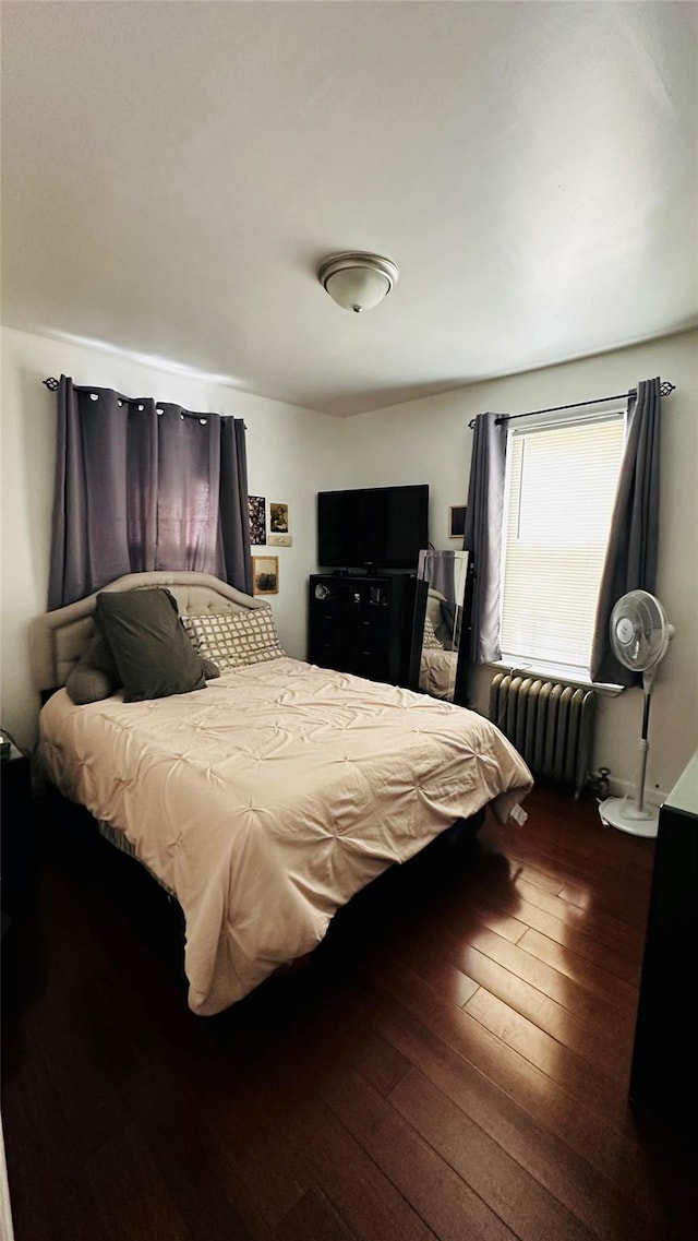 bedroom featuring dark hardwood / wood-style floors and radiator