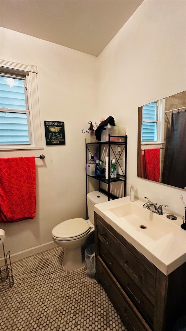 bathroom featuring tile patterned flooring, vanity, and toilet