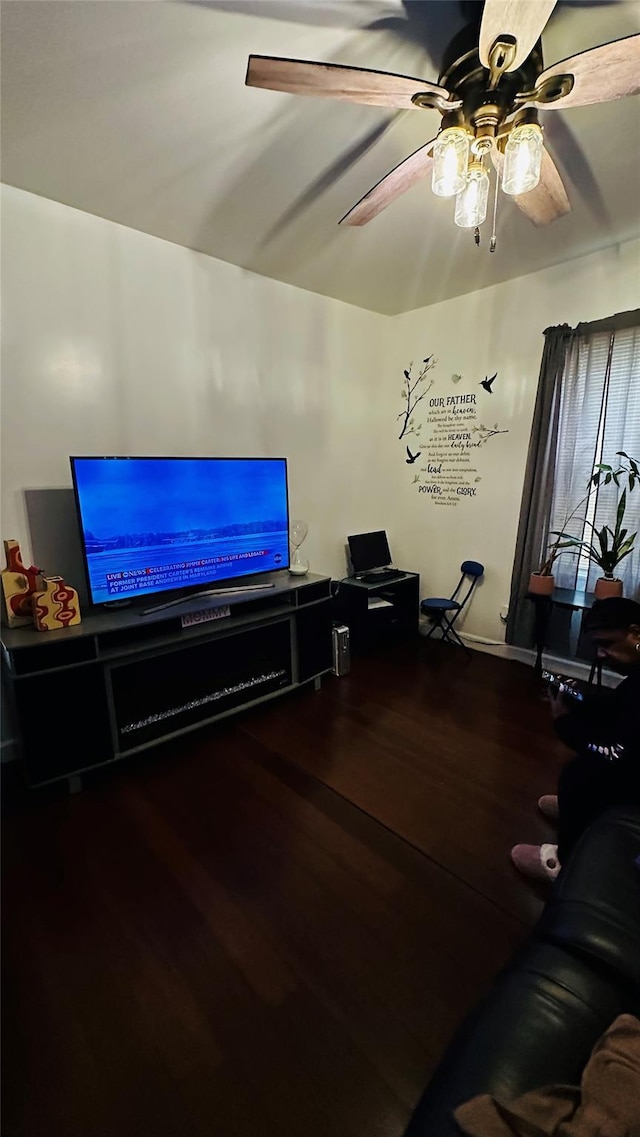 living room featuring ceiling fan and hardwood / wood-style flooring