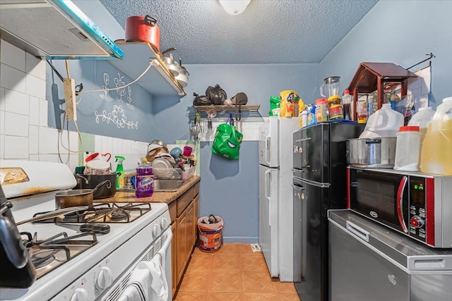 kitchen with sink, exhaust hood, a textured ceiling, and white gas range oven