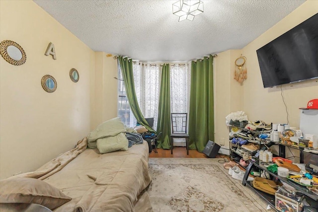 bedroom featuring a textured ceiling and light wood-type flooring