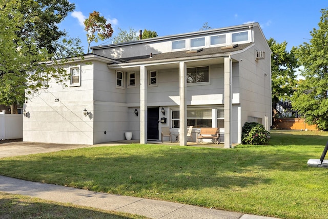 view of front of house with a patio area and a front yard