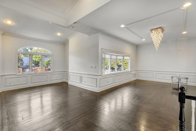 spare room with crown molding, plenty of natural light, and a notable chandelier