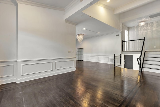 unfurnished room featuring ornamental molding, dark wood-type flooring, and an inviting chandelier