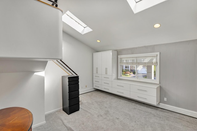 bonus room featuring lofted ceiling with skylight, light colored carpet, and a baseboard radiator