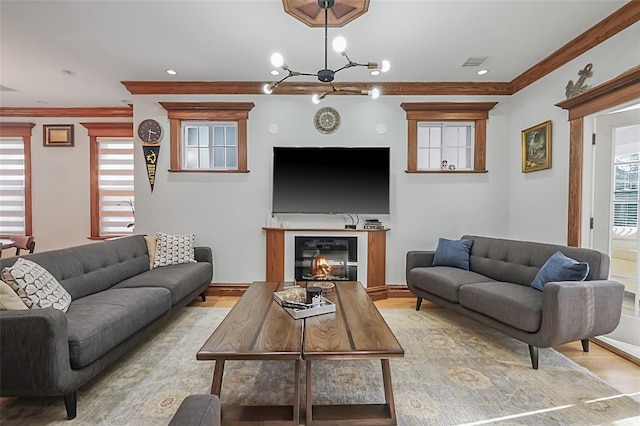 living area with a healthy amount of sunlight, light wood-style floors, and visible vents