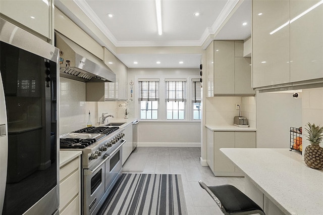 kitchen with under cabinet range hood, range with two ovens, decorative backsplash, and crown molding