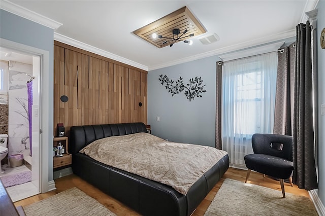 bedroom featuring light wood finished floors and crown molding