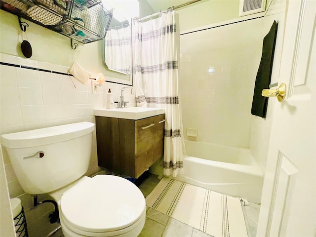 full bathroom with vanity, toilet, tile walls, and shower / tub combo with curtain