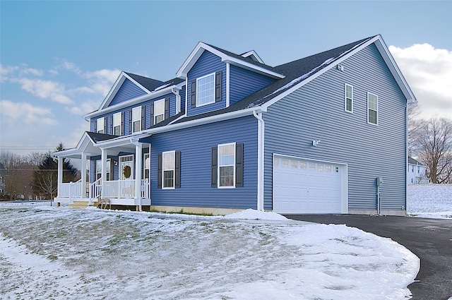 view of front of home with covered porch and a garage