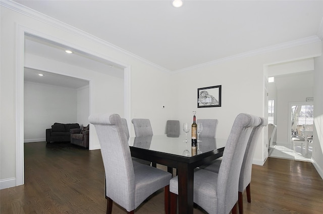 dining room with crown molding and dark hardwood / wood-style floors