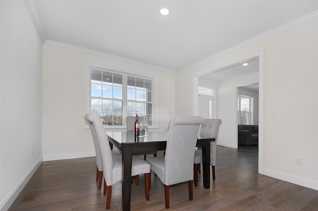 dining space with dark hardwood / wood-style floors and ornamental molding