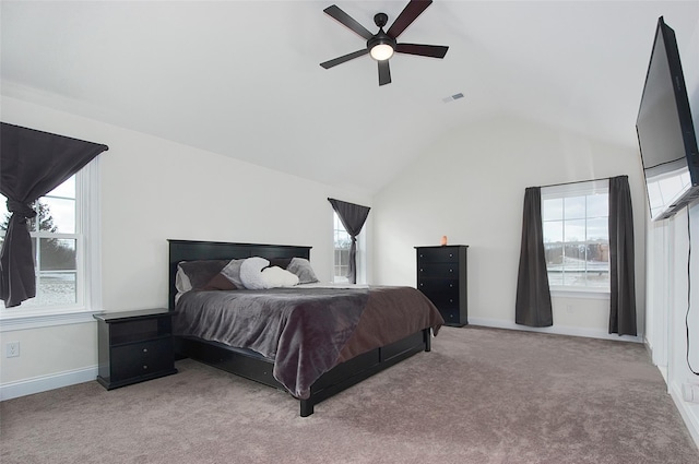 carpeted bedroom featuring multiple windows, ceiling fan, and lofted ceiling