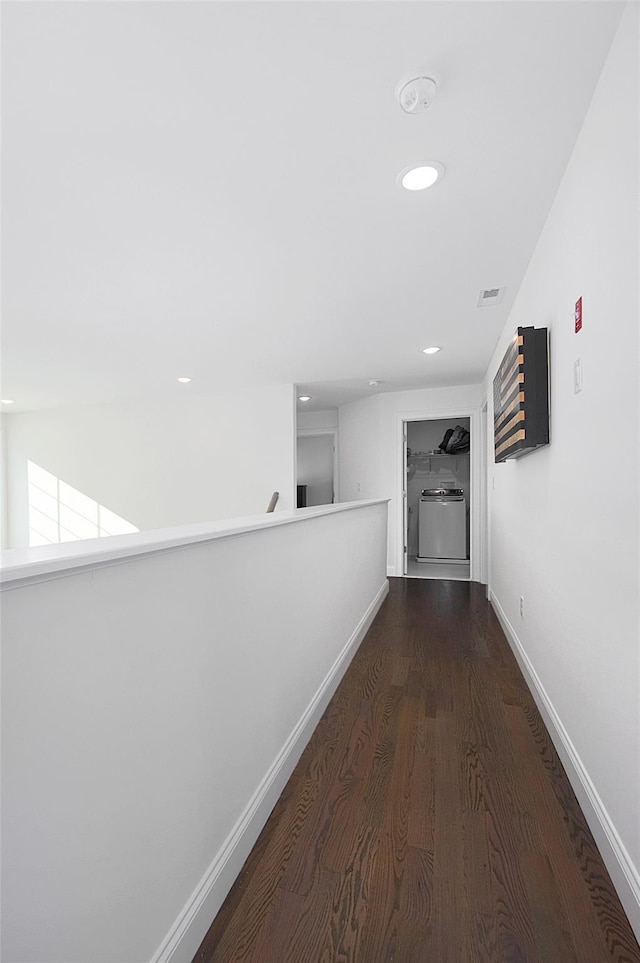 corridor with dark hardwood / wood-style flooring