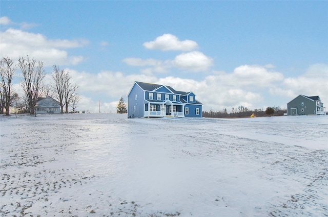 view of snow covered back of property