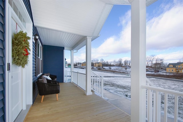 snow covered deck with covered porch