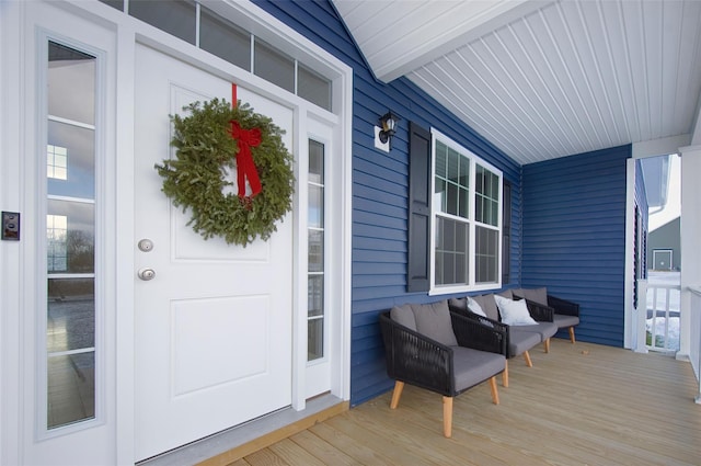 view of exterior entry featuring covered porch