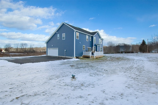 view of snow covered exterior featuring a garage