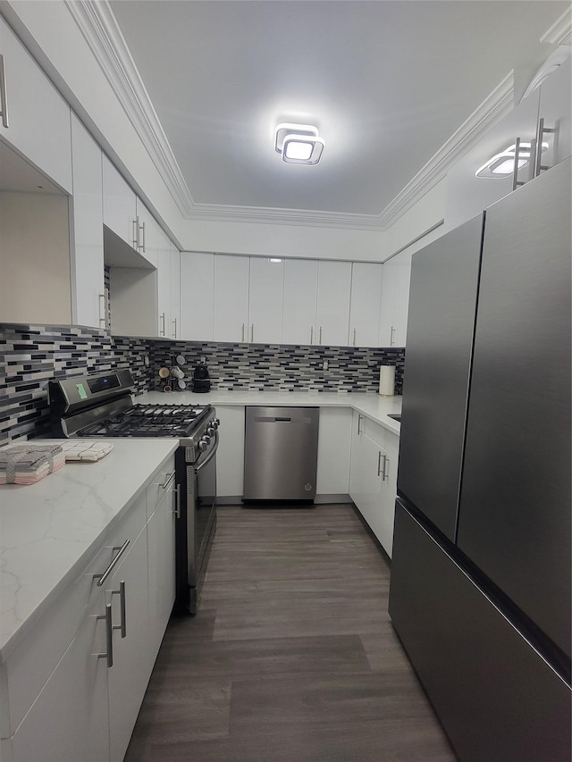 kitchen with decorative backsplash, white cabinetry, and stainless steel appliances