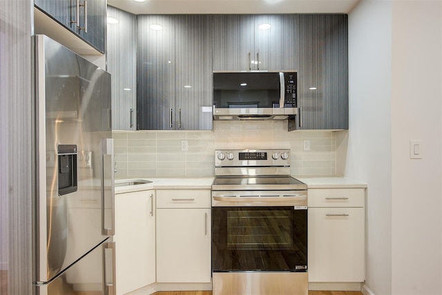 kitchen with tasteful backsplash and appliances with stainless steel finishes