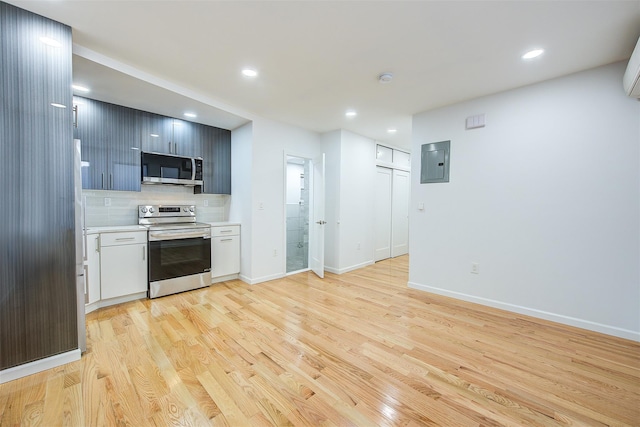 kitchen featuring tasteful backsplash, stainless steel appliances, electric panel, and light hardwood / wood-style flooring