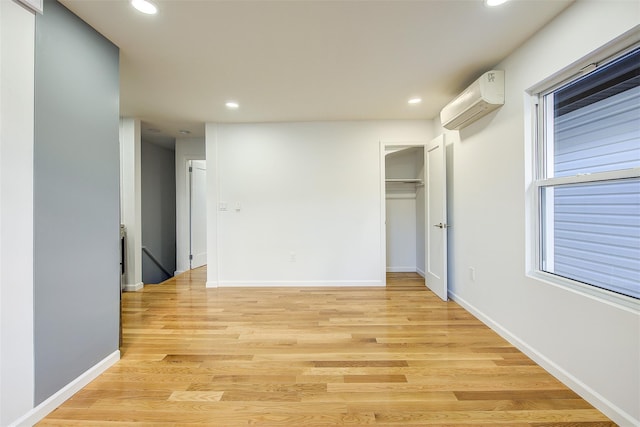 interior space featuring an AC wall unit and light hardwood / wood-style floors