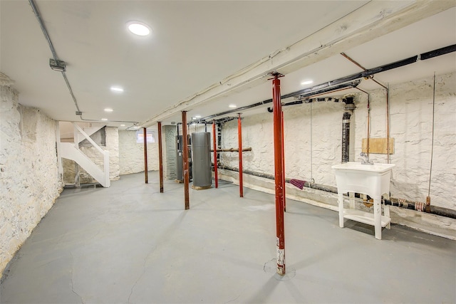 basement featuring water heater and sink