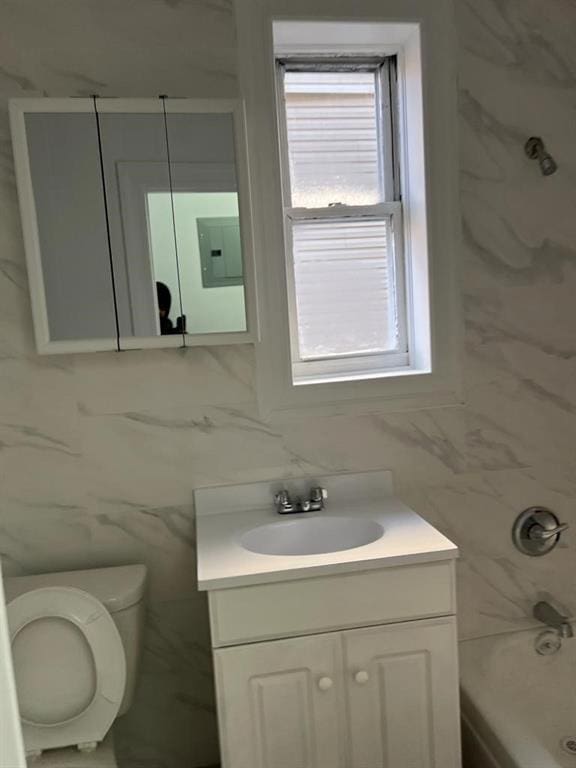 full bathroom featuring decorative backsplash, vanity,  shower combination, electric panel, and toilet