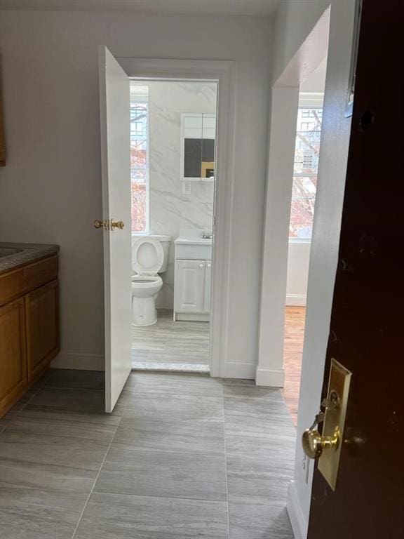 bathroom featuring toilet, vanity, and tile patterned floors