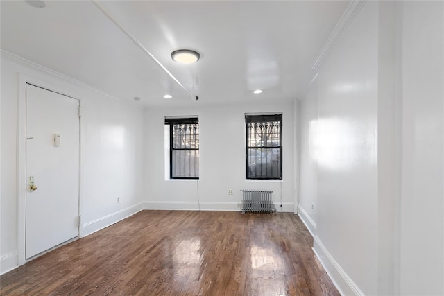 spare room with crown molding and hardwood / wood-style flooring