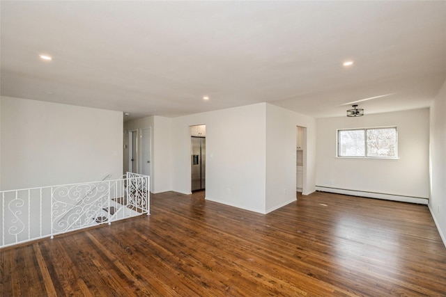 unfurnished room with a baseboard radiator and dark wood-type flooring