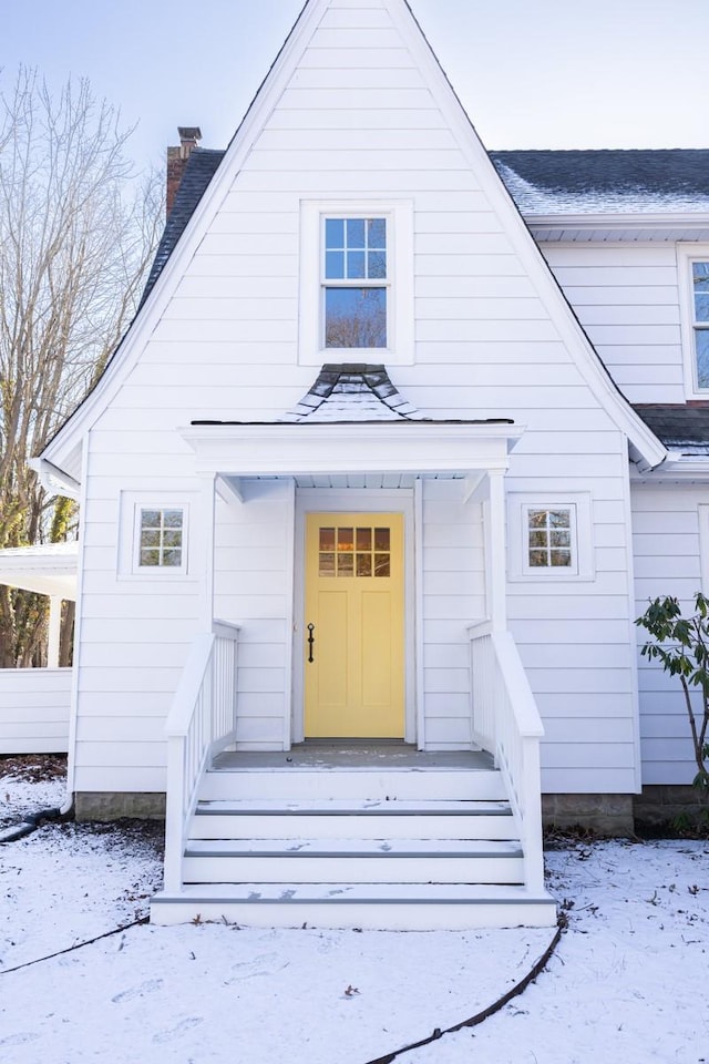 view of snow covered property entrance