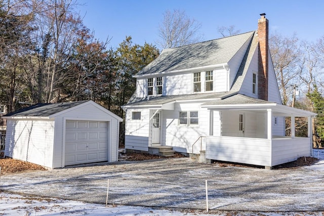 view of front facade featuring a garage and an outbuilding