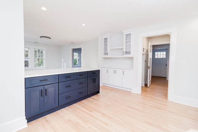 kitchen featuring white cabinets and light wood-type flooring