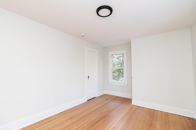 spare room with hardwood / wood-style flooring