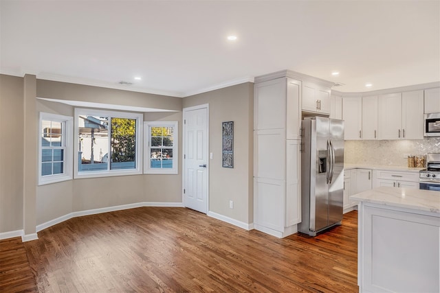 kitchen featuring white cabinets, decorative backsplash, light stone countertops, dark hardwood / wood-style flooring, and stainless steel appliances