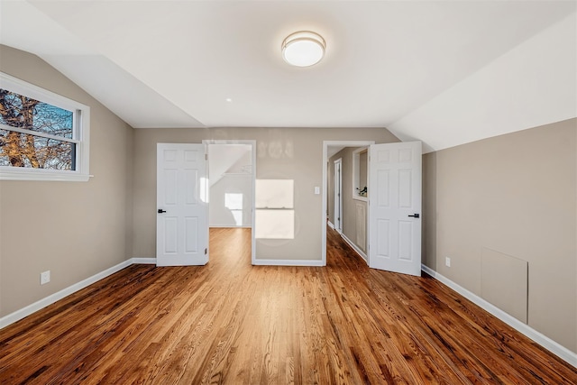 bonus room featuring vaulted ceiling and hardwood / wood-style flooring