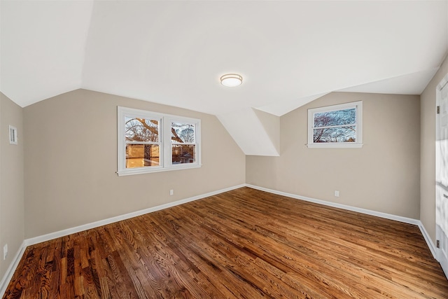 bonus room with lofted ceiling and light wood-type flooring