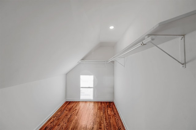 spacious closet featuring wood-type flooring and vaulted ceiling