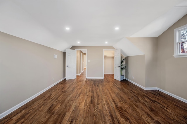 bonus room with vaulted ceiling and dark hardwood / wood-style floors