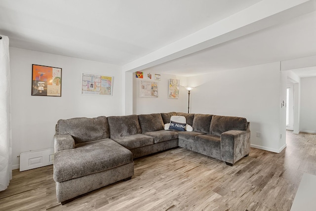 living area featuring baseboards and light wood-style floors